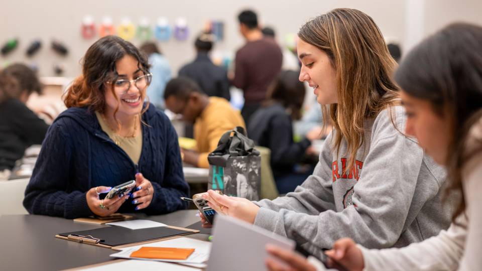 Students smile as they work on an art project