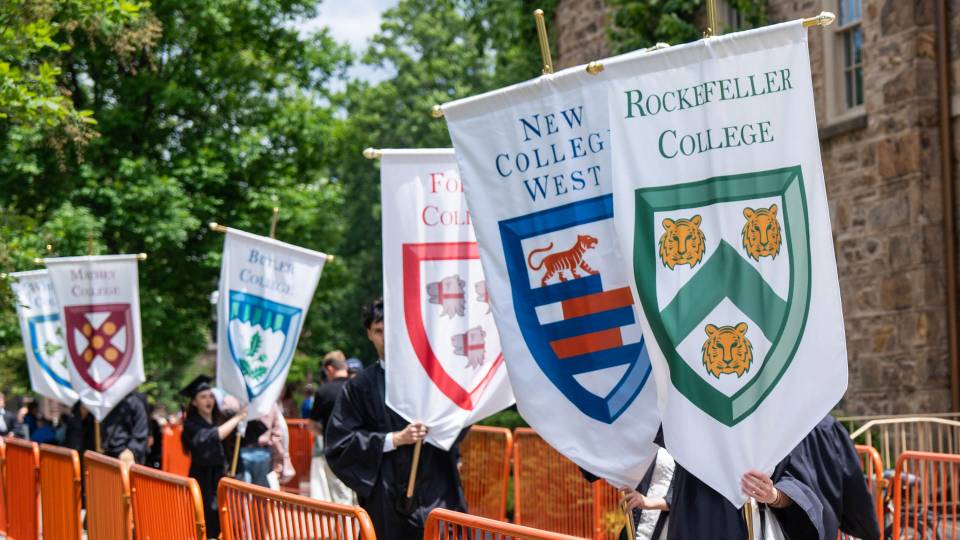 Students parading with gonfalons representing Princeton's Residential Colleges