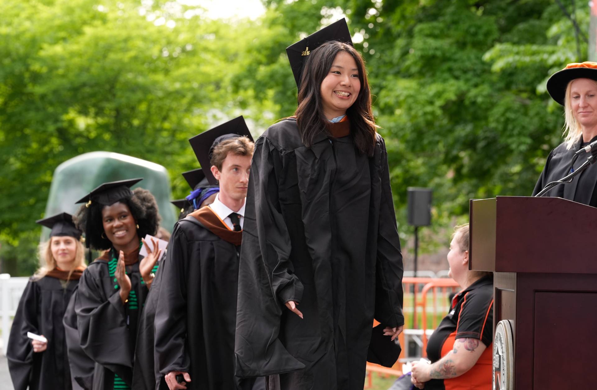A line of students in caps and gowns