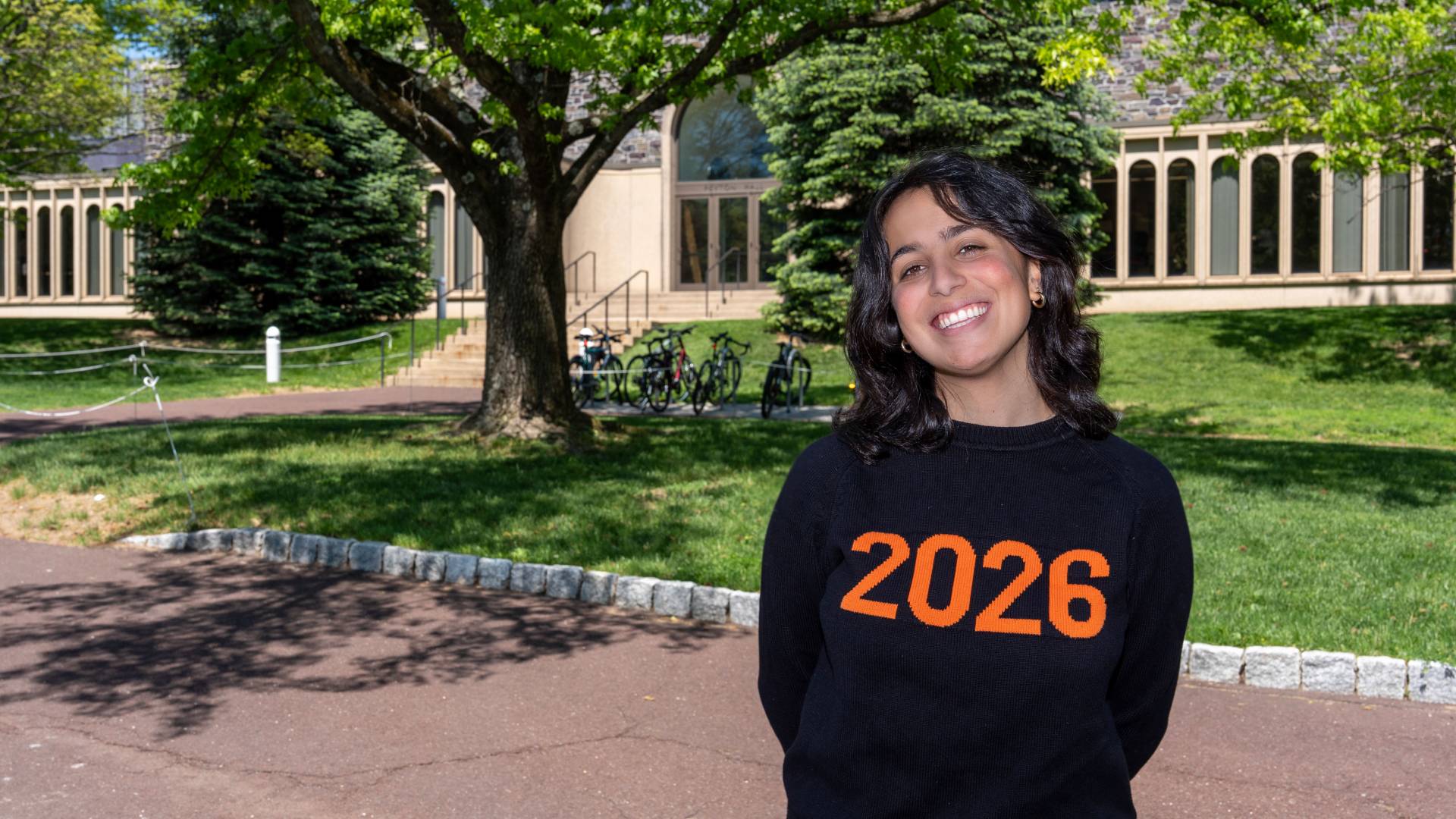Sophia Varughese in front of Peyton Hall