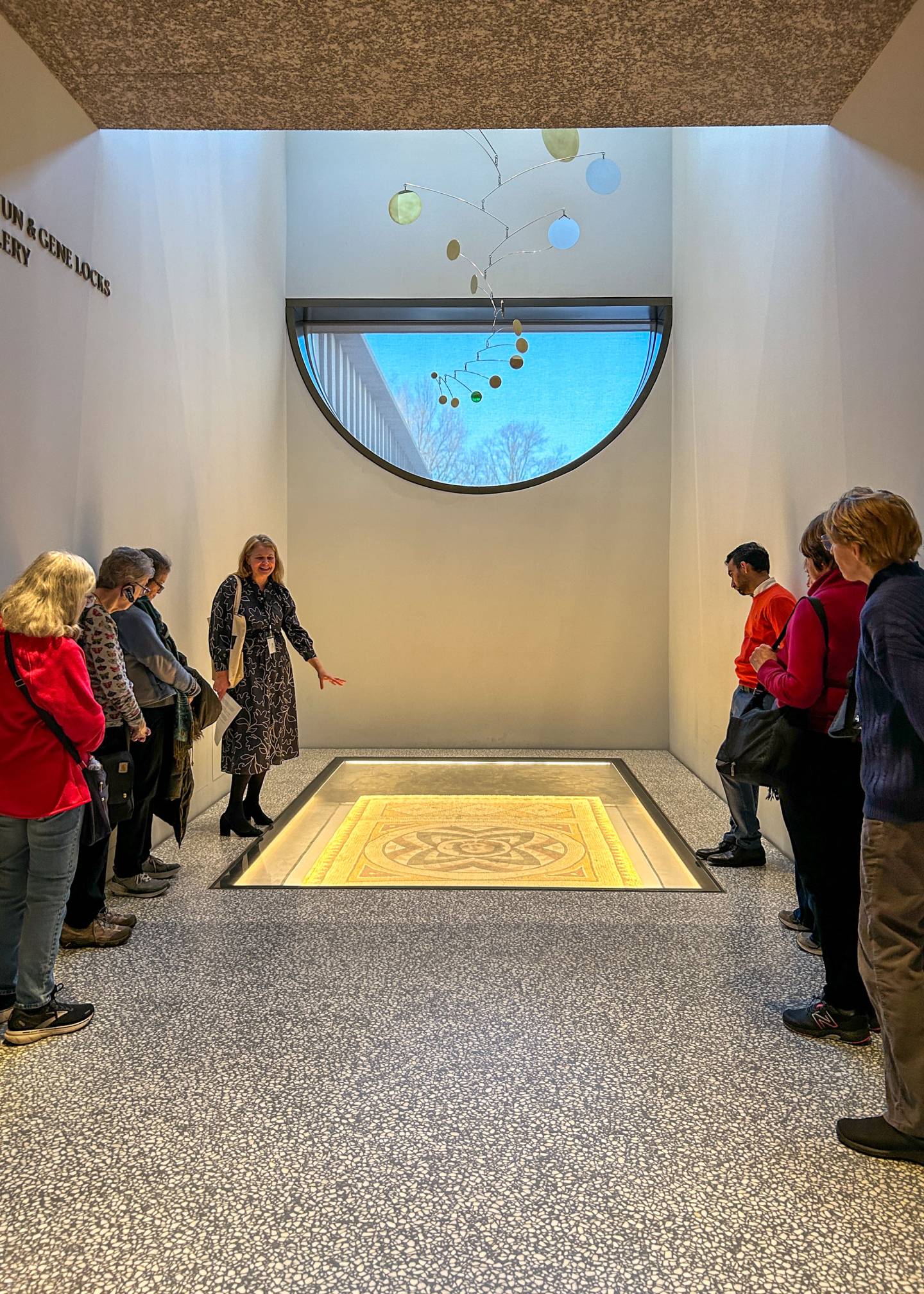 Visitors explore an ancient Roman floor mosaic and a contemporary mobile exhibited together at Princeton's museum.